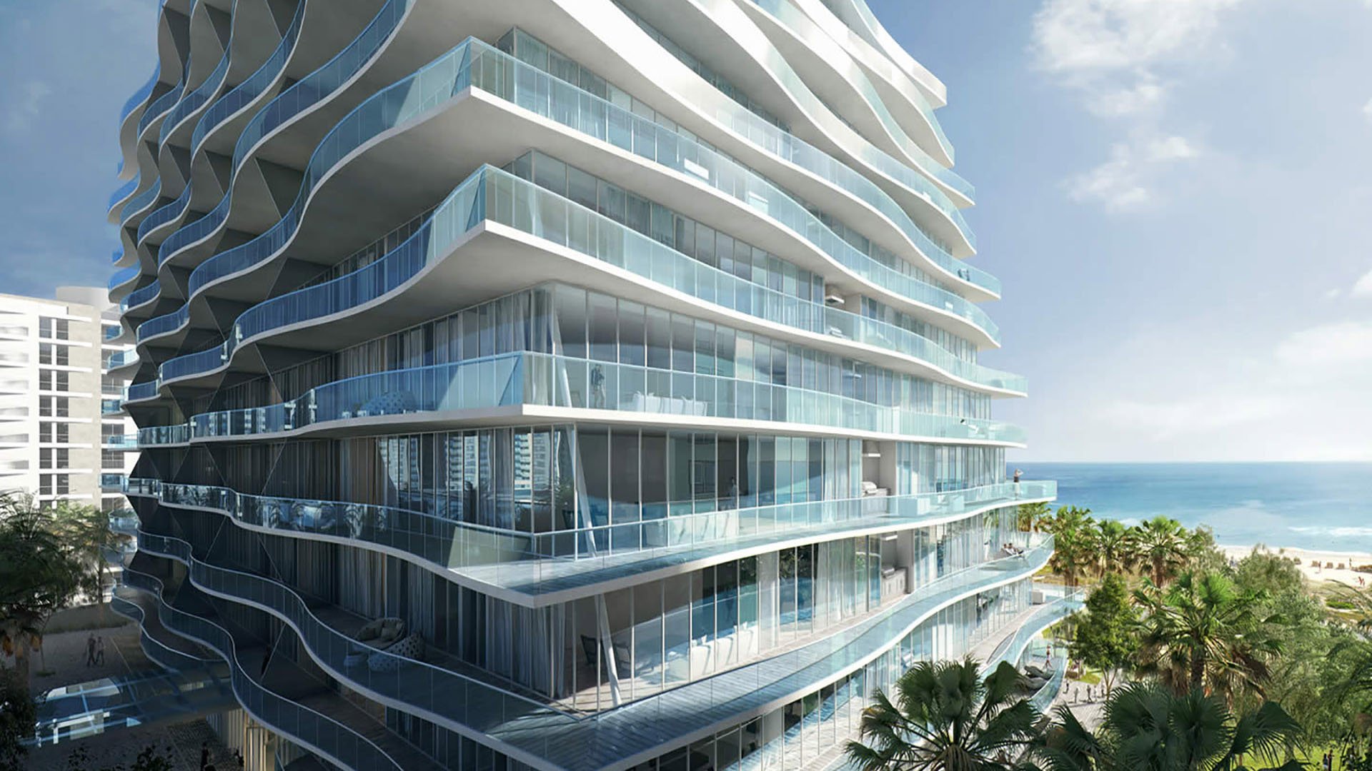 Closeup of the curved glass balconies at Fendi Chateau Residences in Surfside overlooking palms and the beach, emphasizing the architecture of luxury and ultra luxury condos.