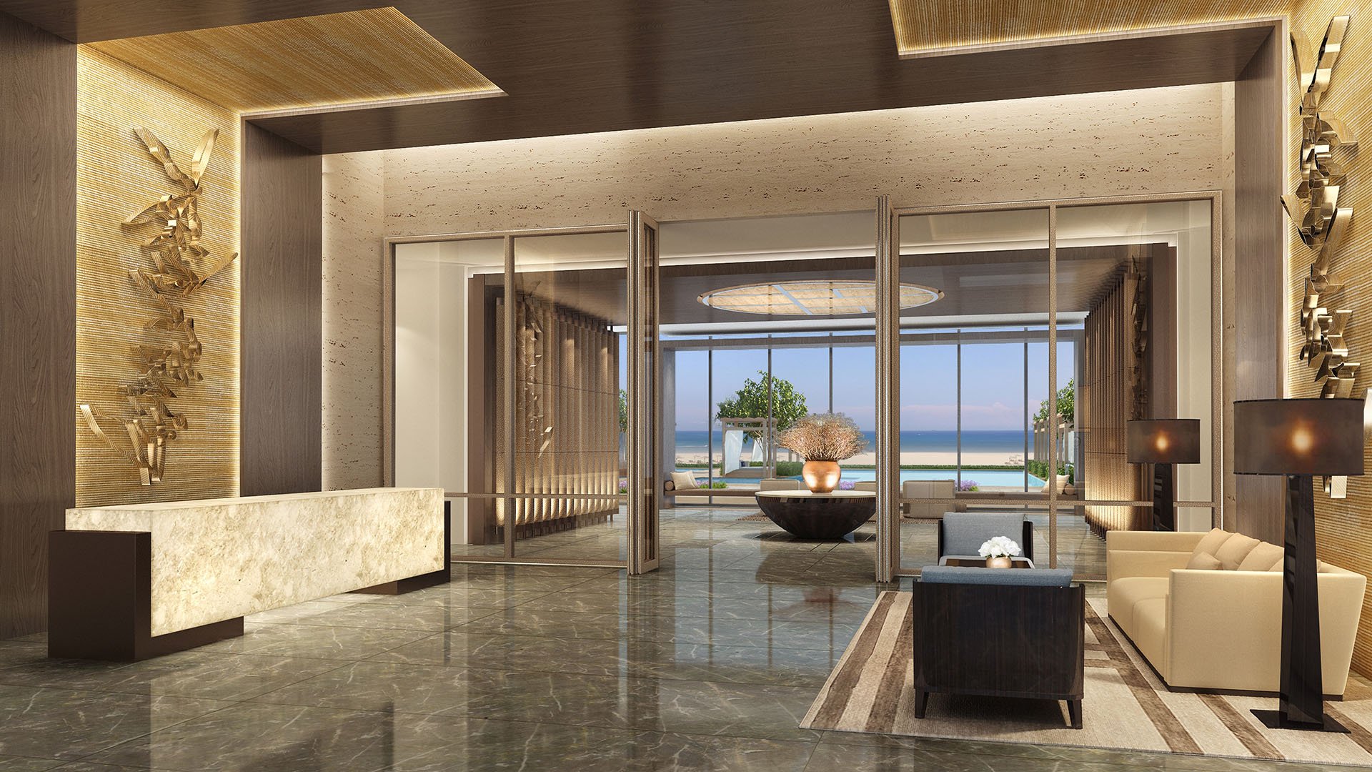 Reception lobby at Fendi Chateau Residences in Surfside with a marble desk, seating area, and framed ocean view, introducing luxury and ultra luxury condos.