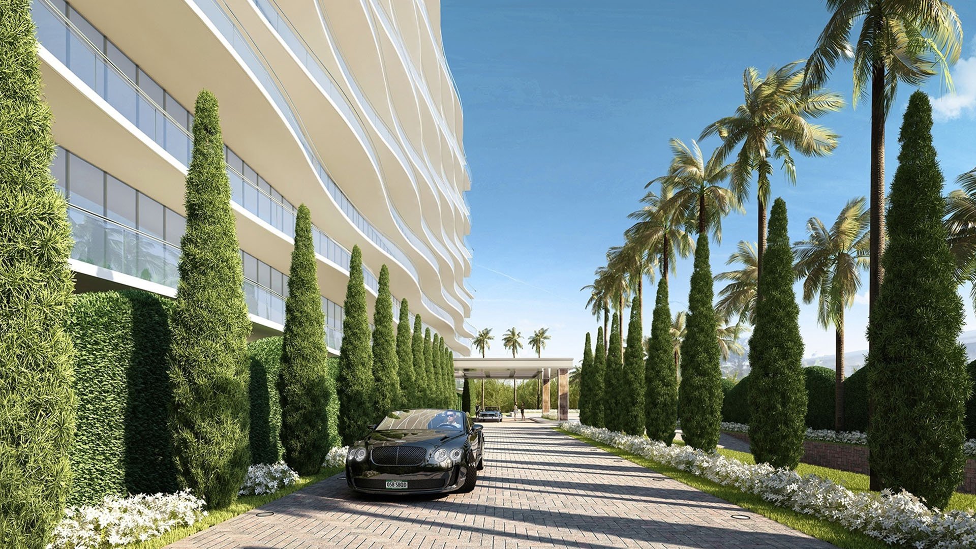 Palm-lined arrival drive at Fendi Chateau Residences in Surfside beside the sculpted facade, creating a grand approach to luxury and ultra luxury condos.