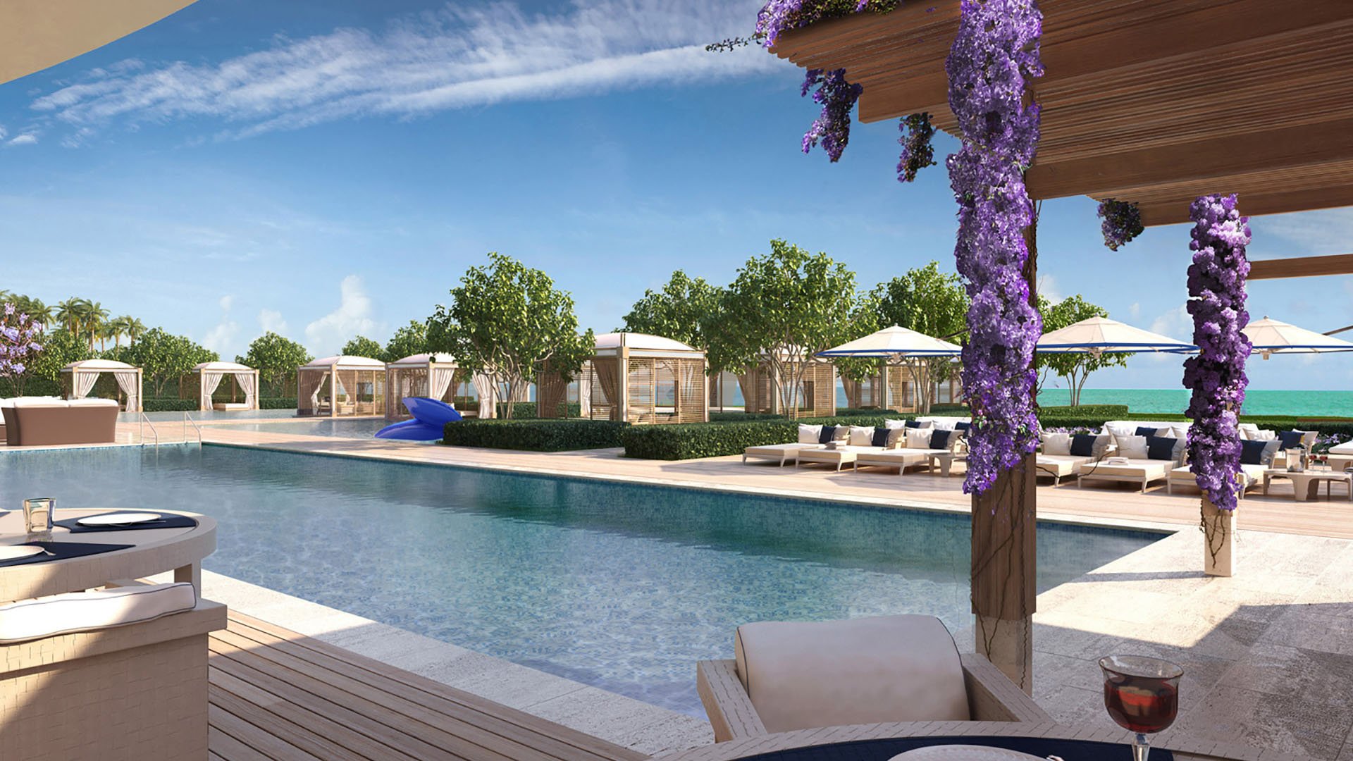 Poolside pergola lounge at Fendi Chateau Residences in Surfside with shaded seating, flowering trellises, and cabanas, complementing luxury and ultra luxury condos.