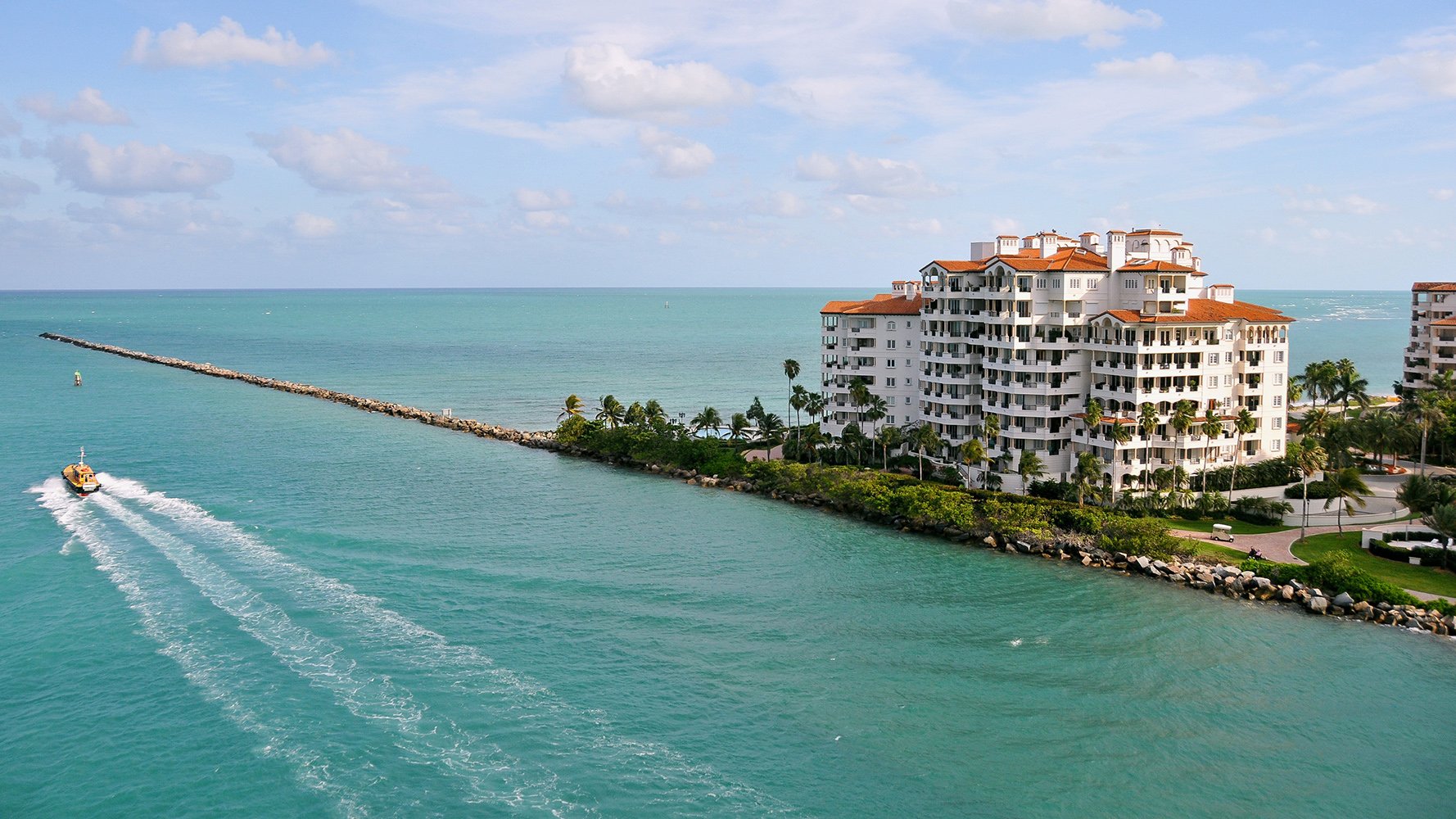 Fisher Island, Miami waterfront condo with passing boat, private island lifestyle of luxury and ultra luxury condos; coveted resale. Featuring coastal view.