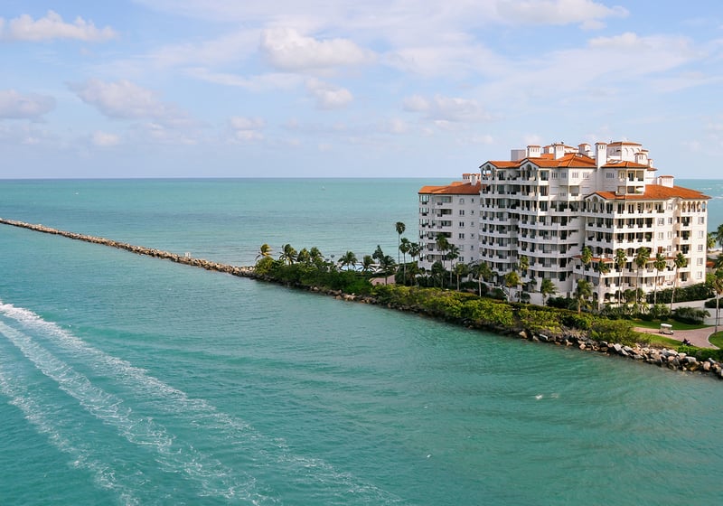 Fisher Island, Miami waterfront condo with passing boat, private island lifestyle of luxury and ultra luxury condos; coveted resale. Featuring coastal view.