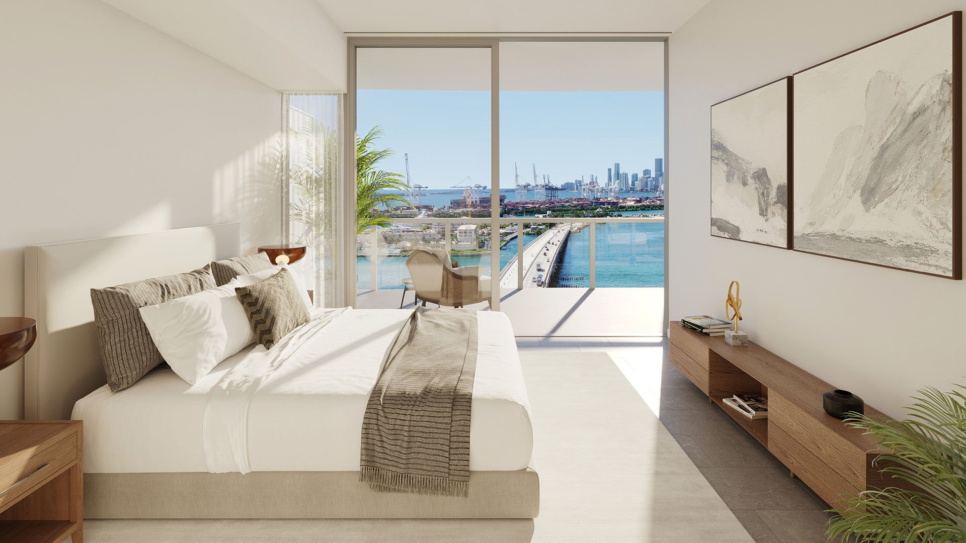 Bedroom facing a bay, bridge and skyline view at Five Park in Miami Beach, luxury and ultra luxury condos with a private balcony and floor to ceiling glass.