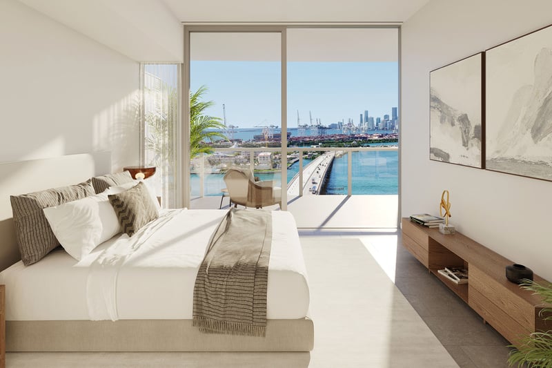 Bedroom facing a bay, bridge and skyline view at Five Park in Miami Beach, luxury and ultra luxury condos with a private balcony and floor to ceiling glass.