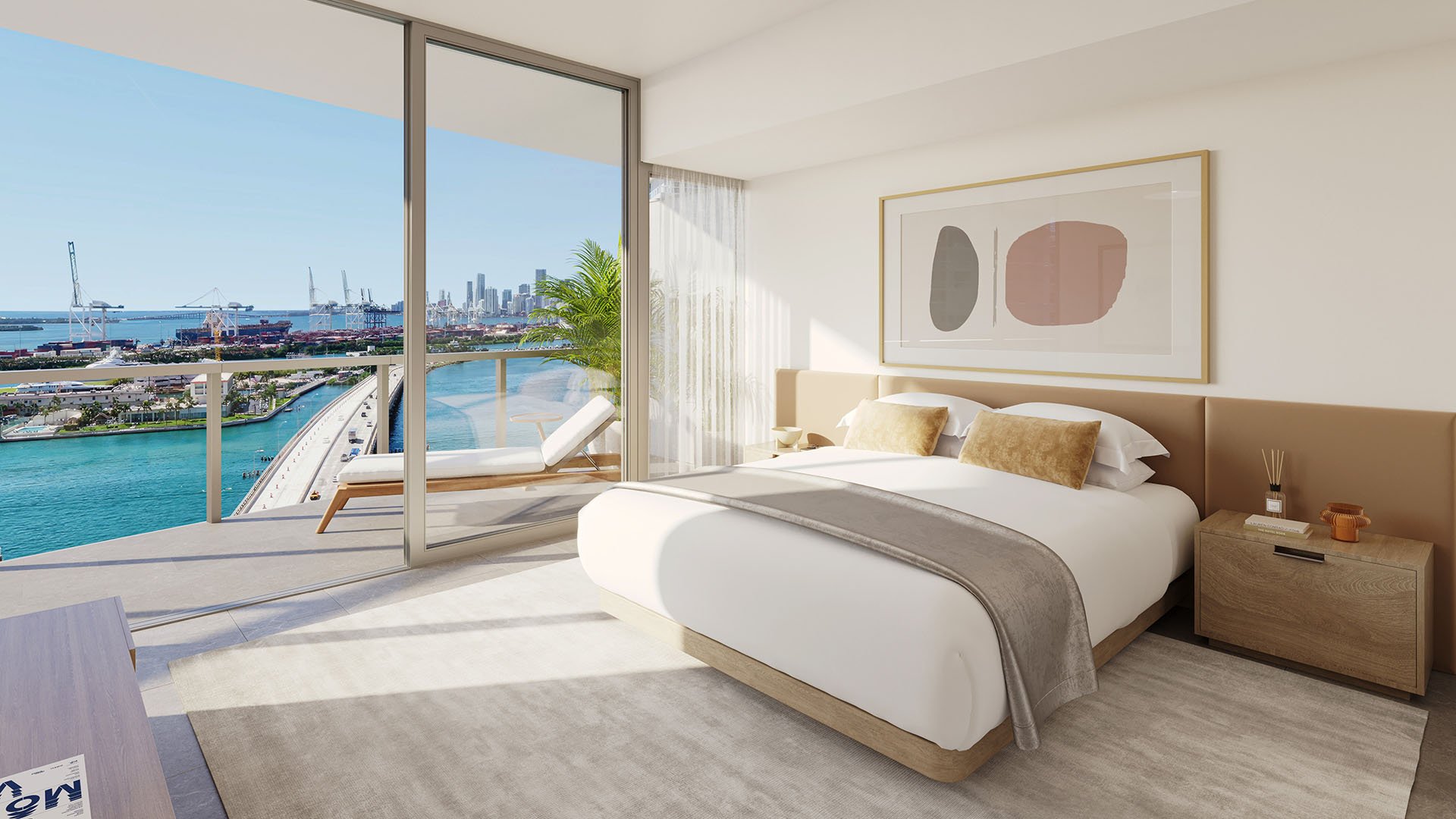 Modern bedroom at Five Park in Miami Beach, luxury and ultra luxury condos with a bay skyline view, a chaise on the balcony and full height glass doors.