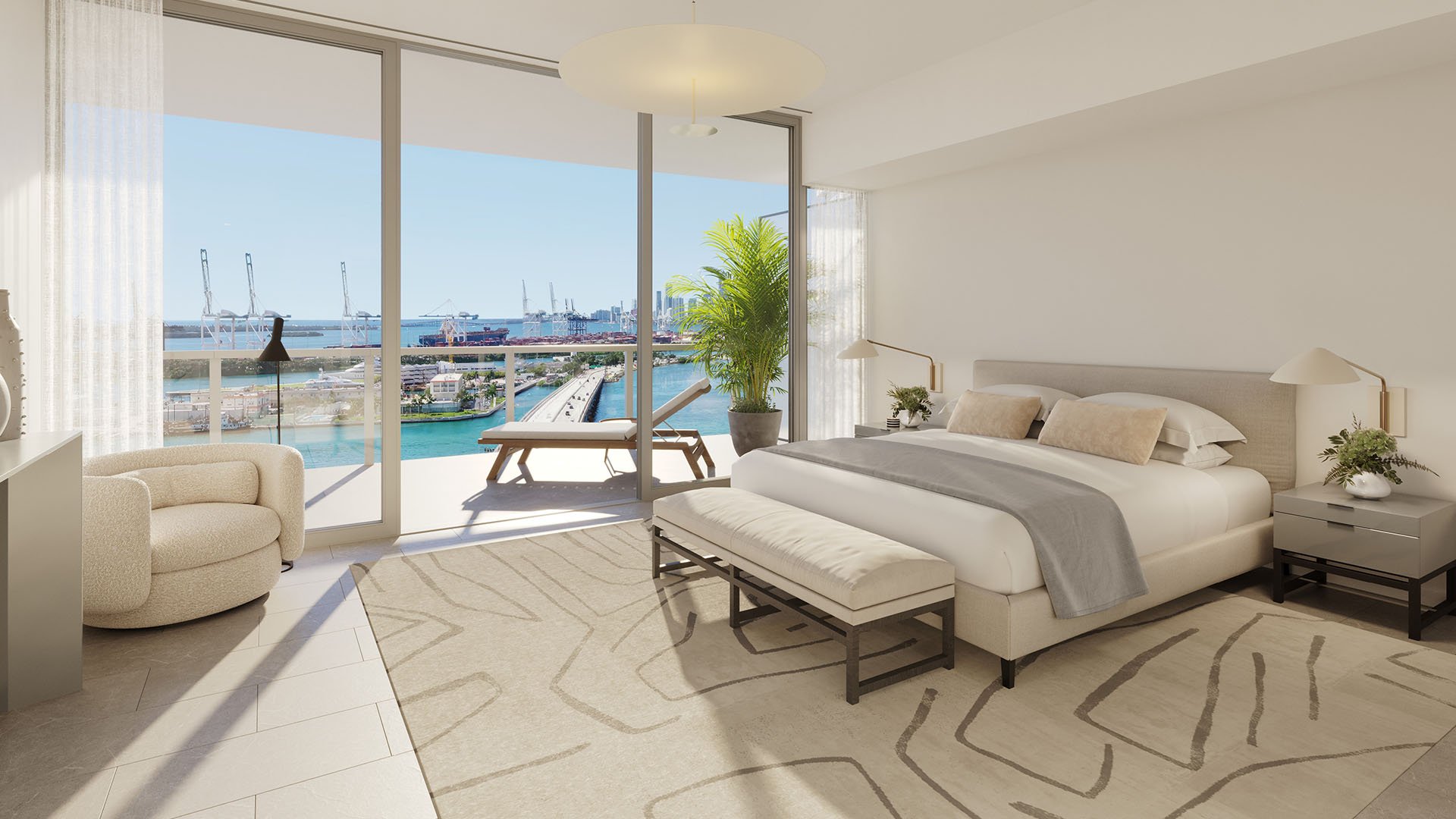 Bright bedroom at Five Park in Miami Beach, luxury and ultra luxury condos with marina views, a private balcony chaise and floor to ceiling sliding glass.