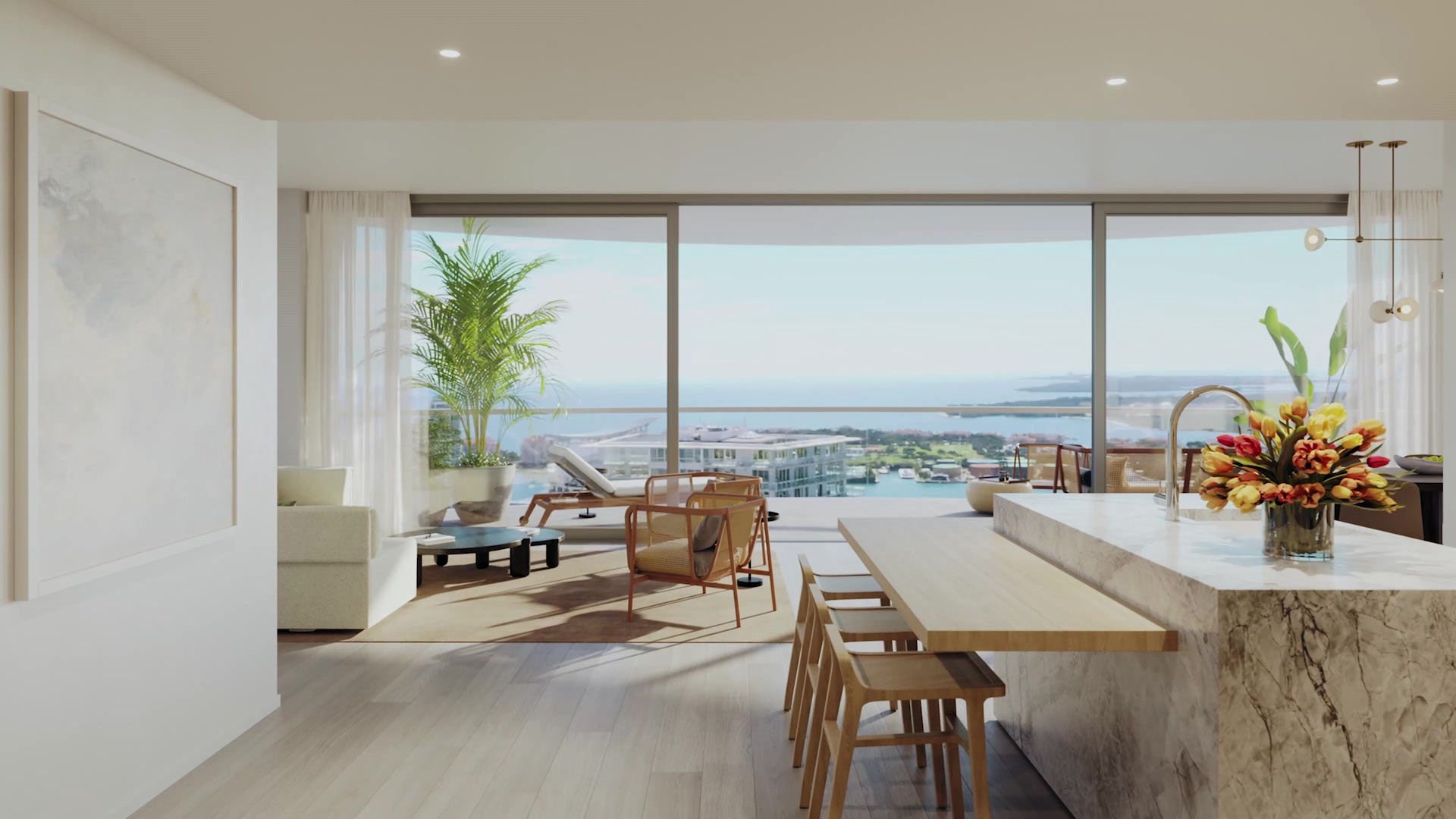 Entry view into the kitchen and terrace at Five Park in Miami Beach, luxury and ultra luxury condos with water views and a marble island.
