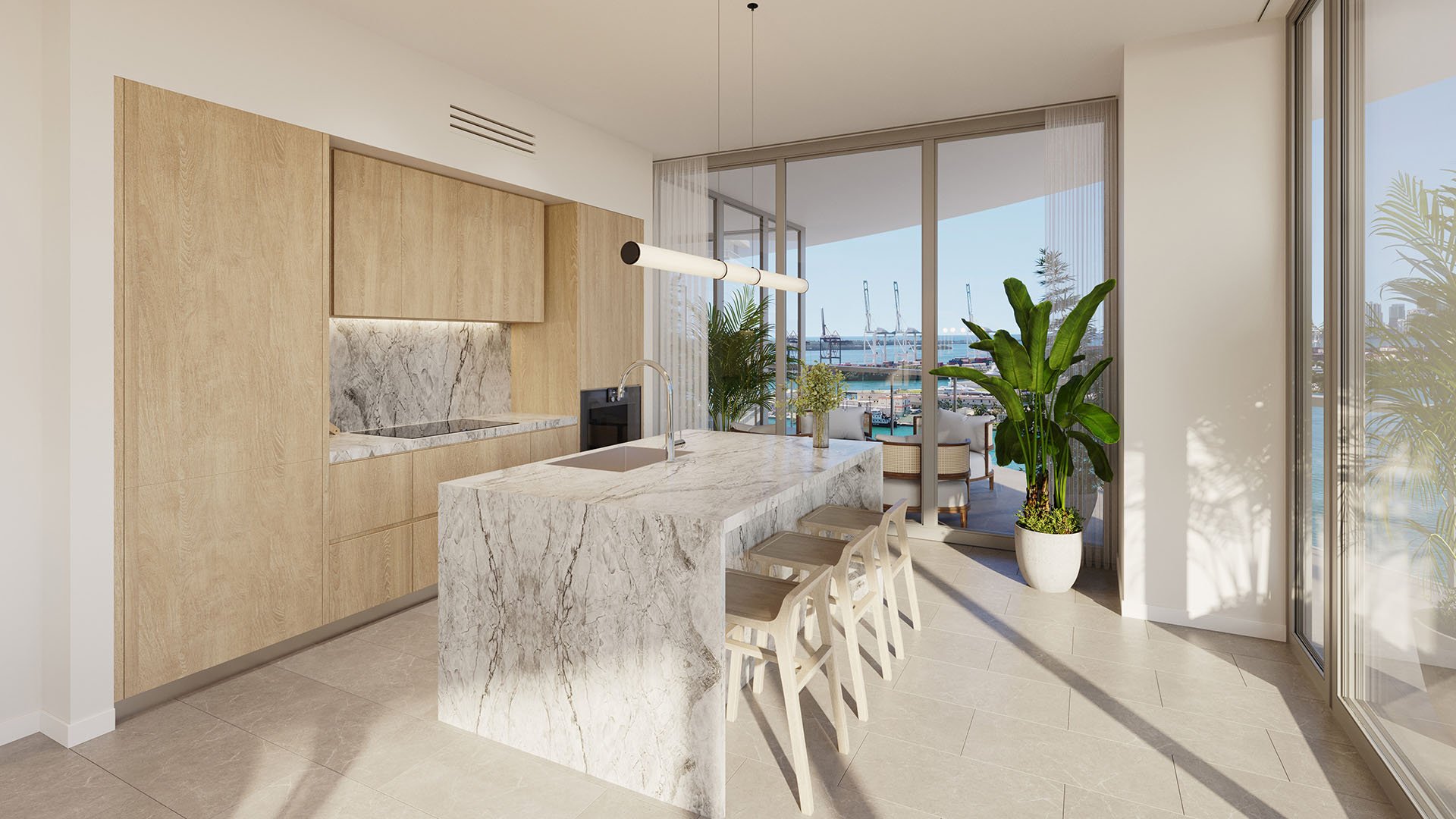 Galley style chef kitchen at Five Park in Miami Beach, luxury and ultra luxury condos with a waterfall island, wood cabinetry and a bay view beyond the glass.