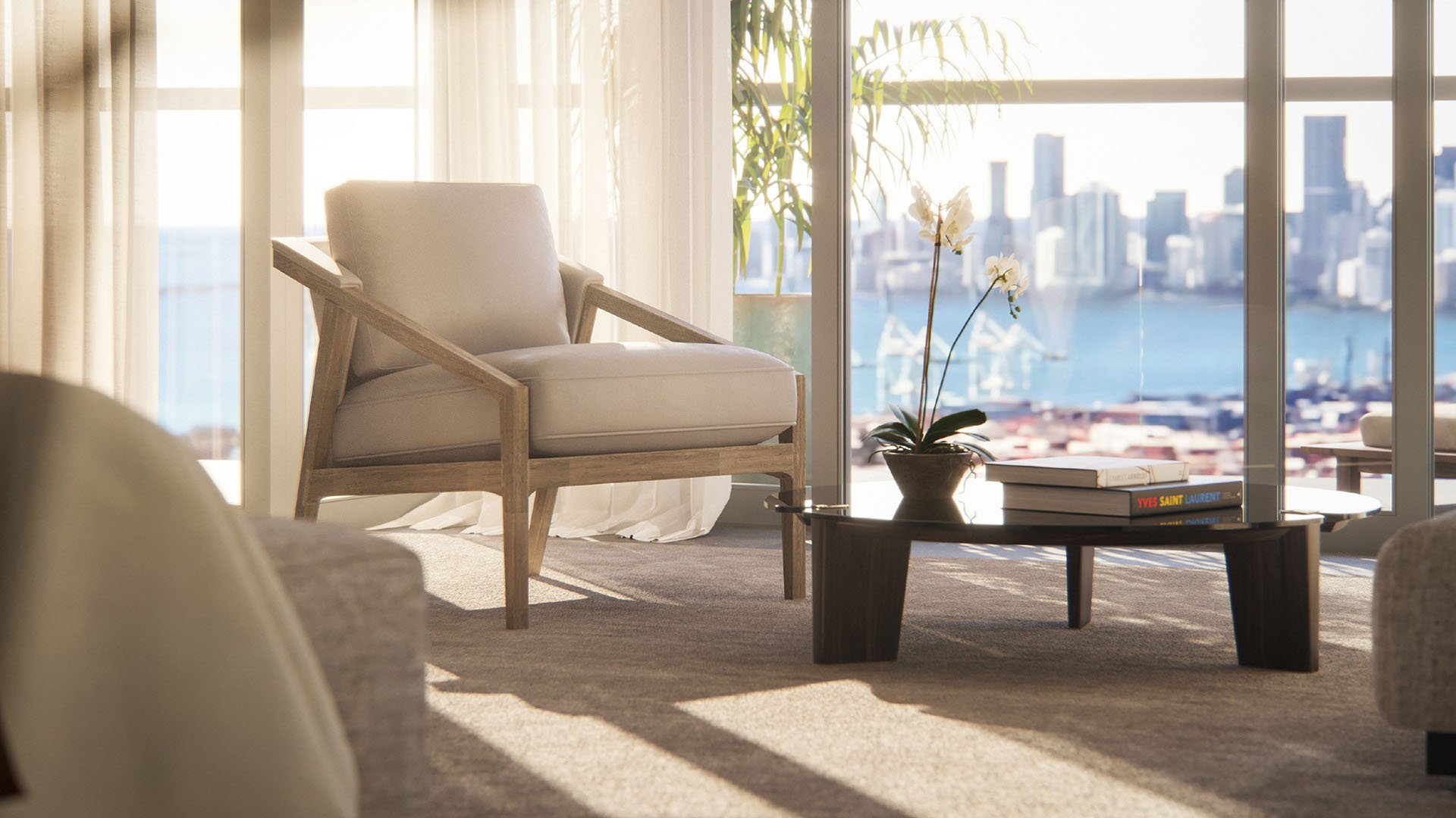 Close interior view with a lounge chair, coffee table and water skyline backdrop at Five Park in Miami Beach, luxury and ultra luxury condos.