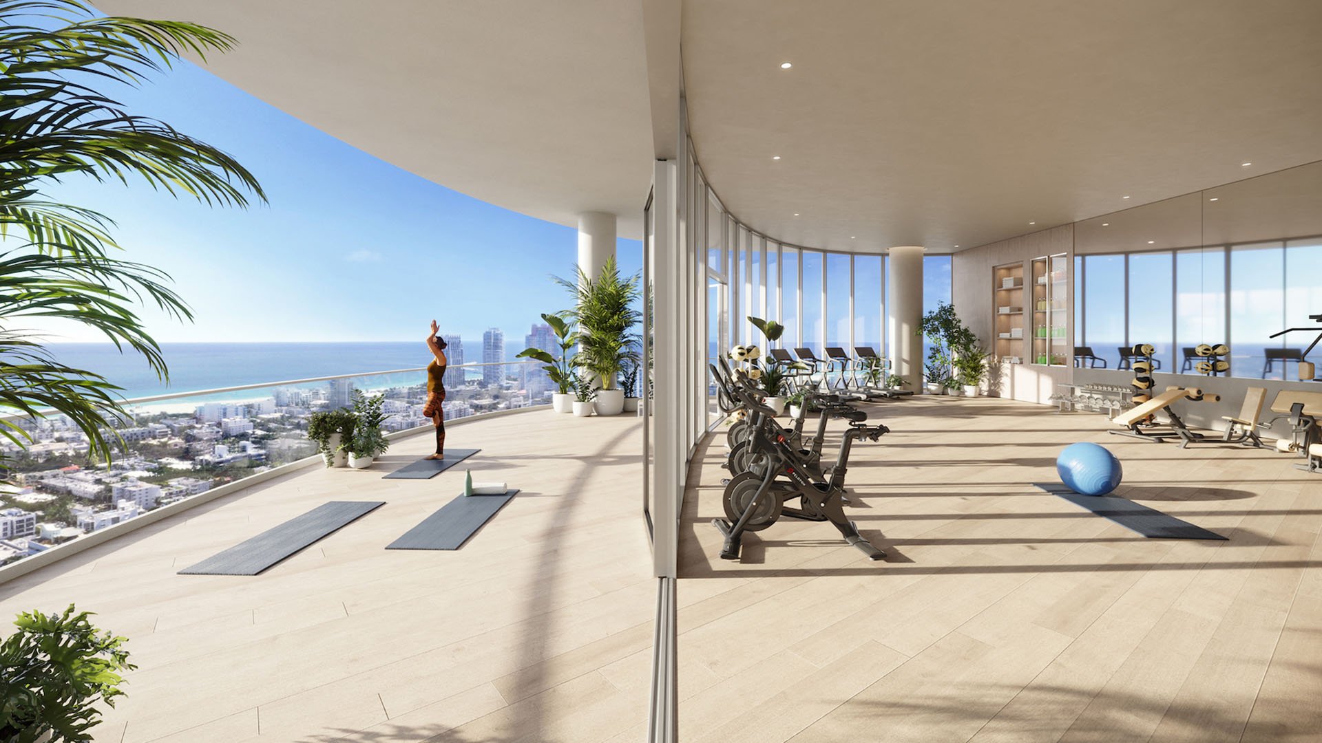 Outdoor fitness terrace at Five Park in Miami Beach, luxury and ultra luxury condos with stationary bikes, yoga mats and sweeping skyline views.