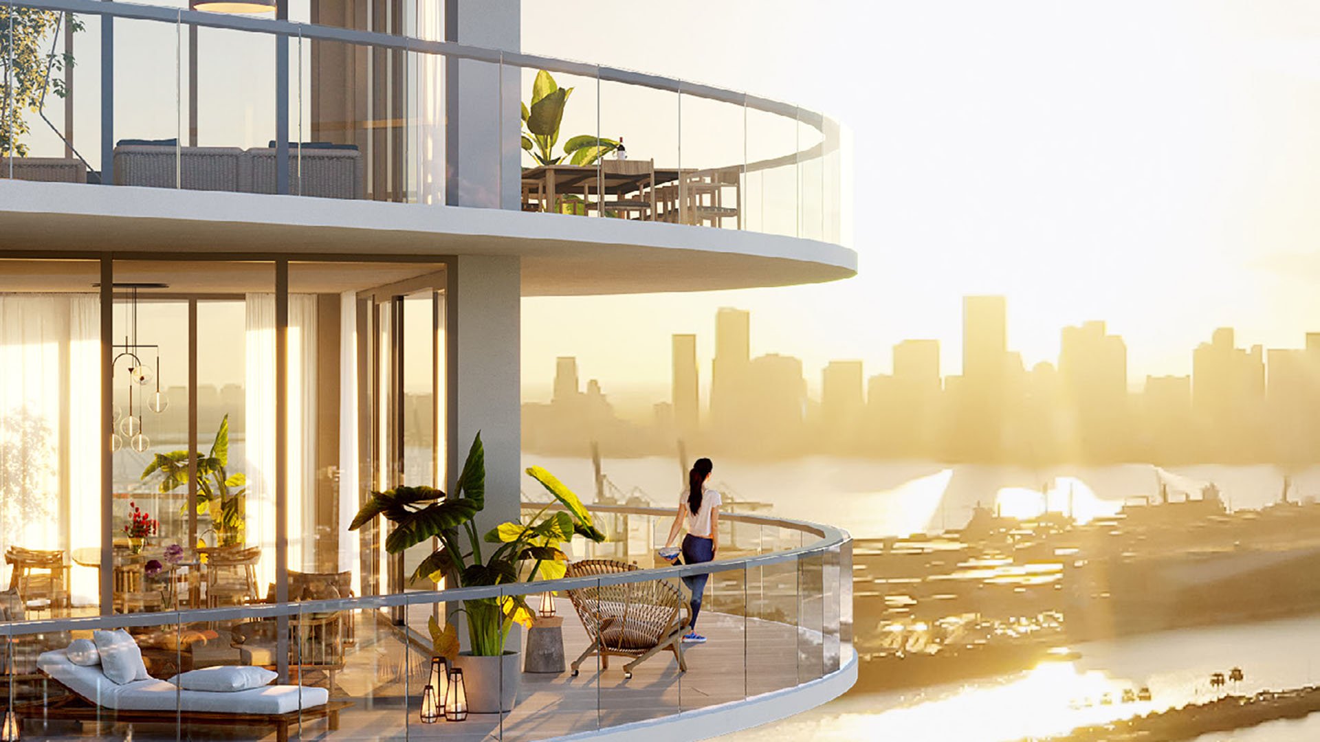 Sunset corner balcony scene at Five Park in Miami Beach, luxury and ultra luxury condos with rounded glass railings, outdoor lounge seating and a glowing skyline backdrop.