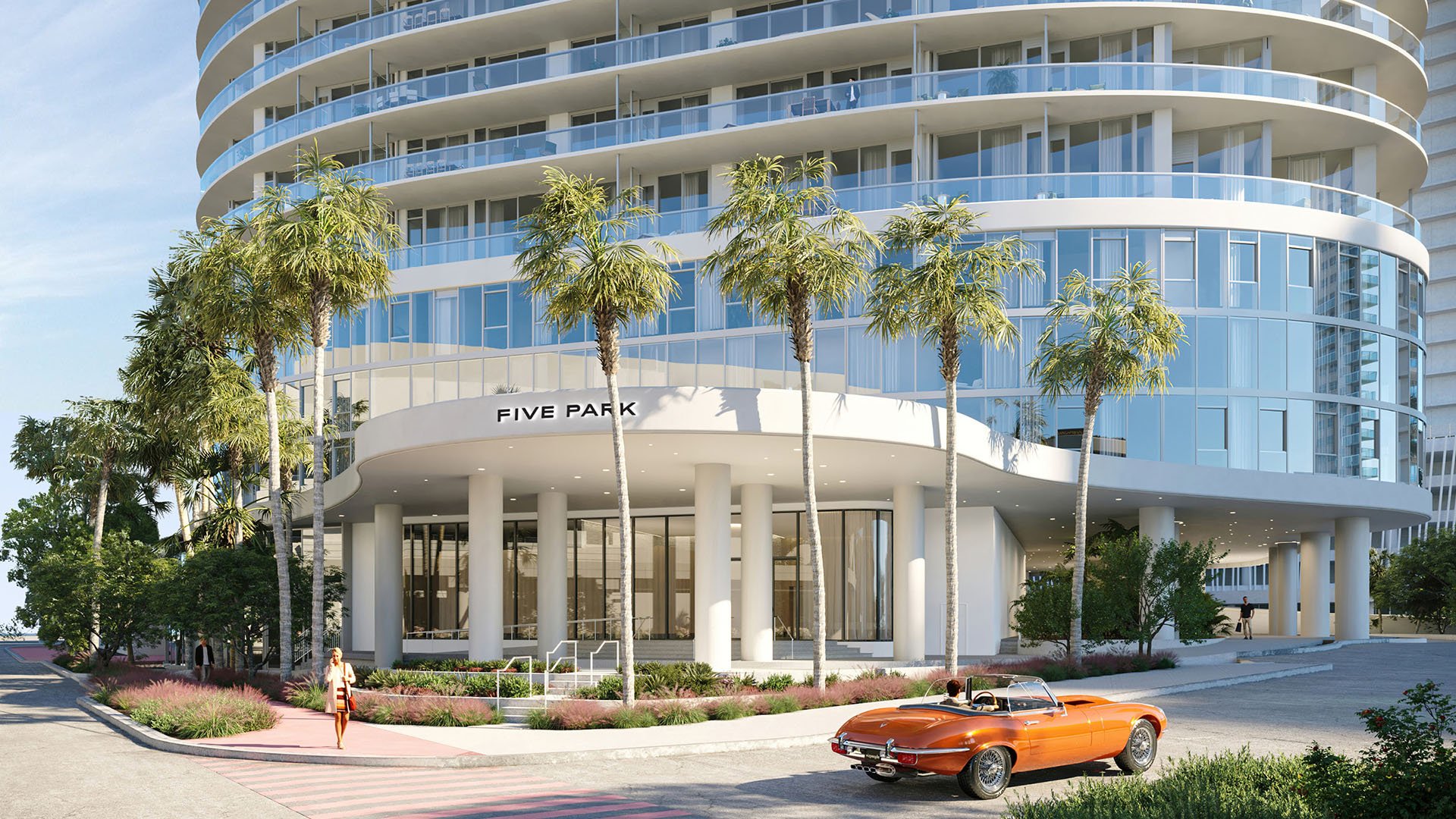 Palm lined tower entrance at Five Park in Miami Beach, luxury and ultra luxury condos with rounded architecture, glass facade and a prominent arrival canopy.