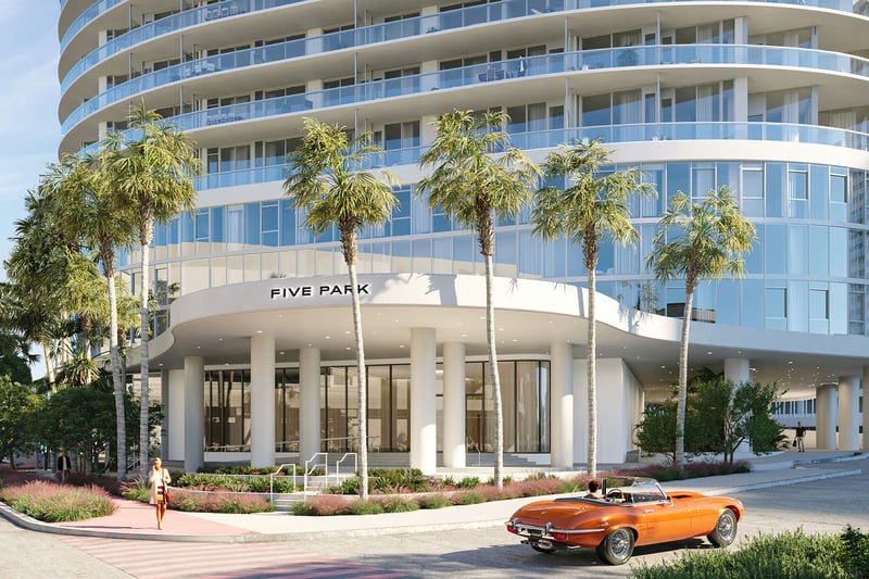 Palm lined tower entrance at Five Park in Miami Beach, luxury and ultra luxury condos with rounded architecture, glass facade and a prominent arrival canopy.