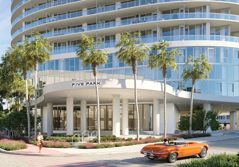 Palm lined tower entrance at Five Park in Miami Beach, luxury and ultra luxury condos with rounded architecture, glass facade and a prominent arrival canopy.