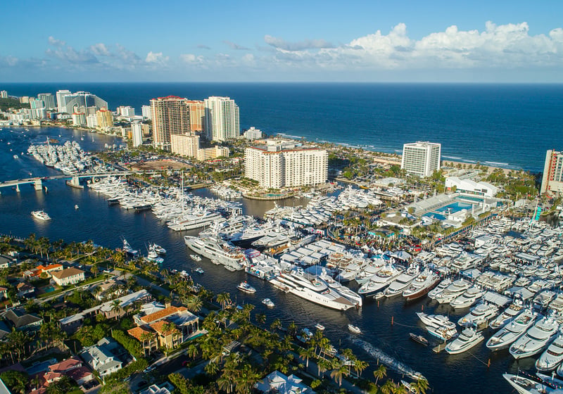 Fort Lauderdale marina aerial with yachts and skyline, prime zone for luxury and ultra luxury condos, offering preconstruction and resale. Featuring view.