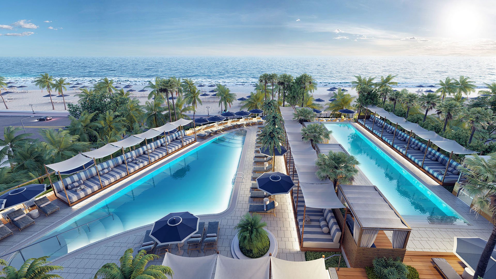 Aerial view of twin oceanfront pools framed by palms and cabanas at Four Seasons Residences Fort Lauderdale in Fort Lauderdale, showcasing luxury and ultra luxury condos with resort-style beachfront amenities.