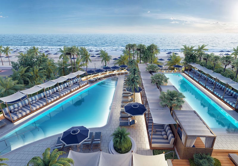 Aerial view of twin oceanfront pools framed by palms and cabanas at Four Seasons Residences Fort Lauderdale in Fort Lauderdale, showcasing luxury and ultra luxury condos with resort-style beachfront amenities.