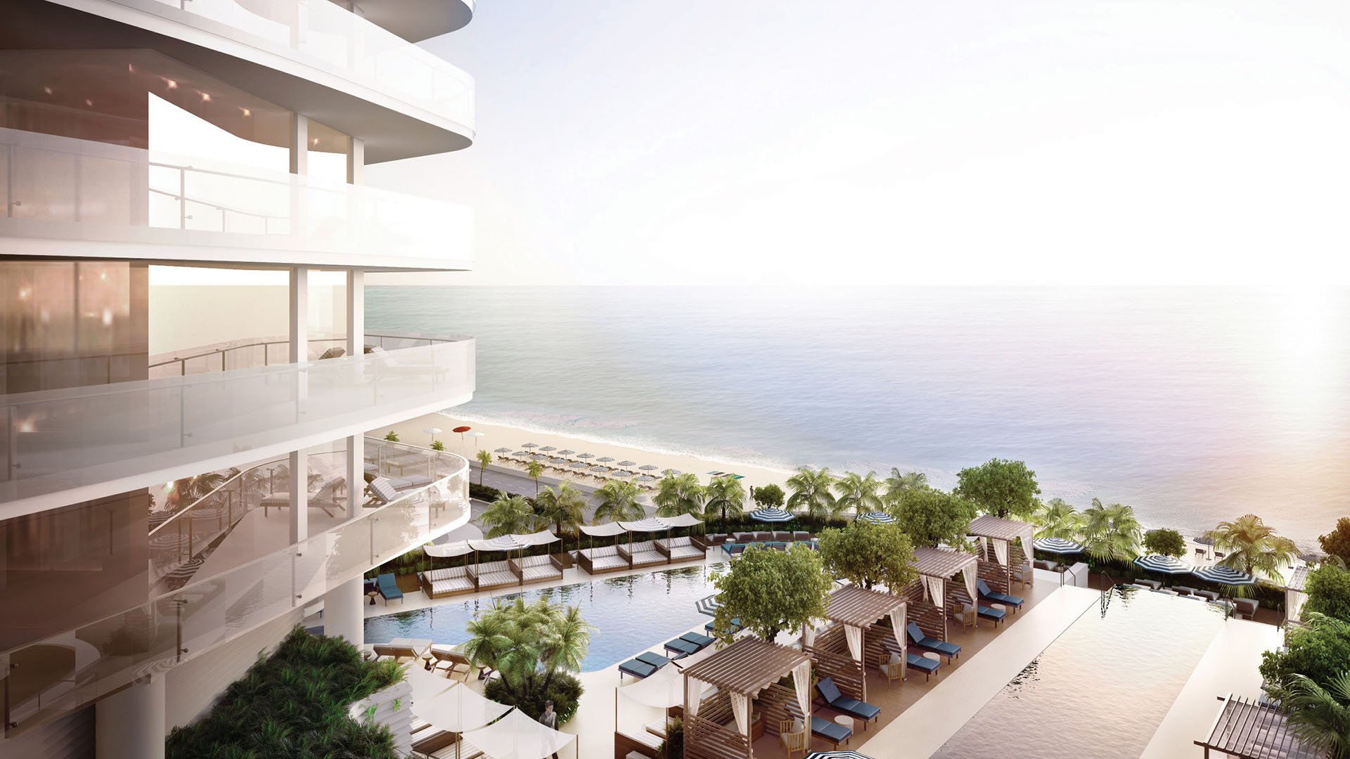 Curved condo balconies overlooking the oceanfront pool deck and cabanas at Four Seasons Residences Fort Lauderdale in Fort Lauderdale, highlighting luxury and ultra luxury condos with seamless indoor-outdoor coastal living.