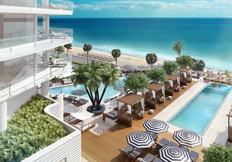 Elevated oceanfront pool deck with private cabanas and beach views at Four Seasons Residences Fort Lauderdale in Fort Lauderdale, showcasing luxury and ultra luxury condos with resort-caliber outdoor amenities.