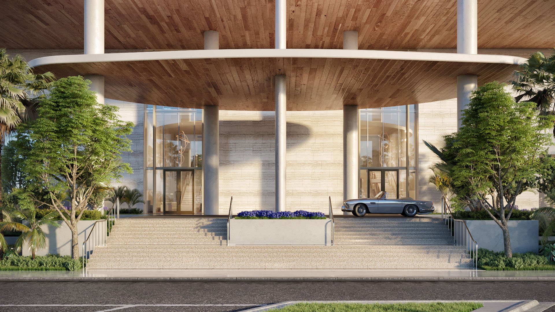 Grand porte cochere entrance with broad steps, tall glass walls, and a classic convertible at Four Seasons Residences Fort Lauderdale in Fort Lauderdale, introducing luxury and ultra luxury condos with a grand arrival.