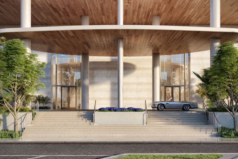 Grand porte cochere entrance with broad steps, tall glass walls, and a classic convertible at Four Seasons Residences Fort Lauderdale in Fort Lauderdale, introducing luxury and ultra luxury condos with a grand arrival.