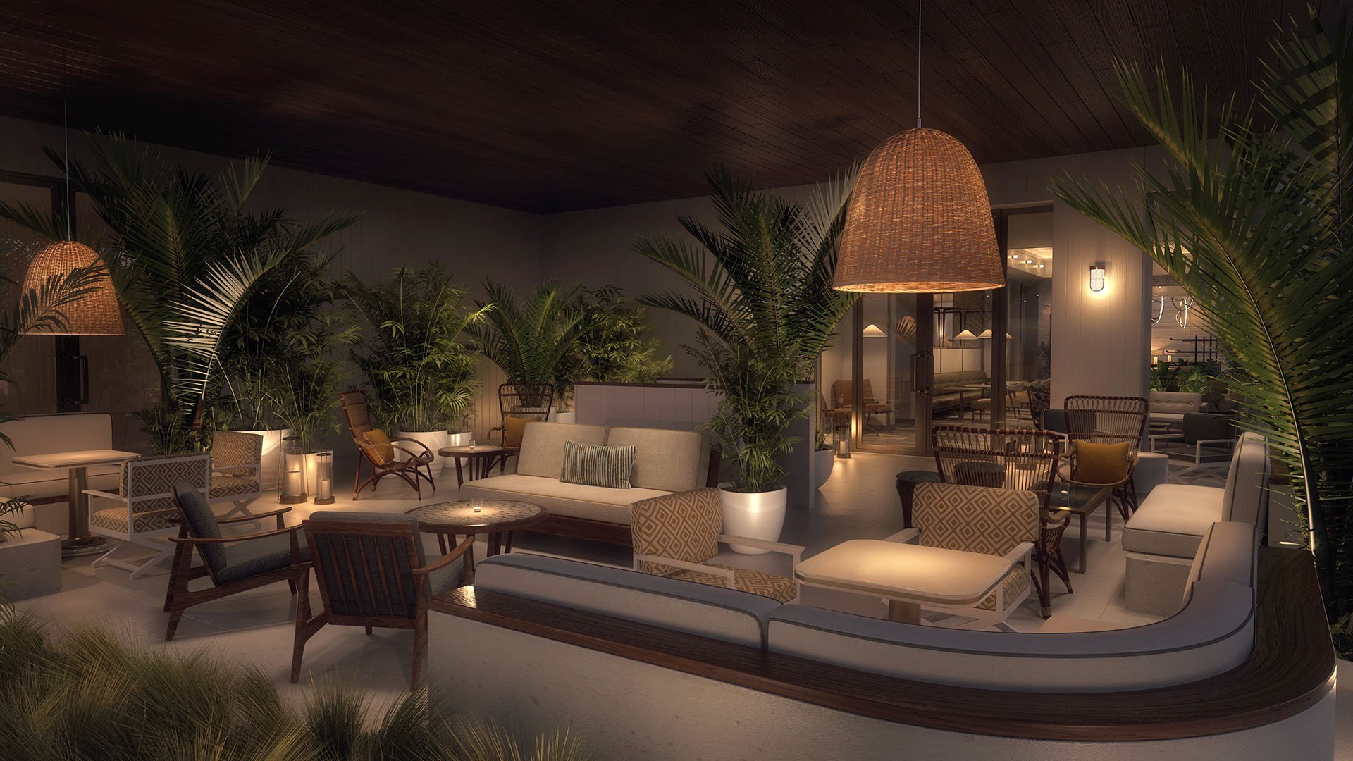 Nighttime covered terrace lounge with a curved banquette, woven pendants, and lush planting at Four Seasons Residences Fort Lauderdale in Fort Lauderdale, presenting luxury and ultra luxury condos with intimate outdoor entertaining areas.