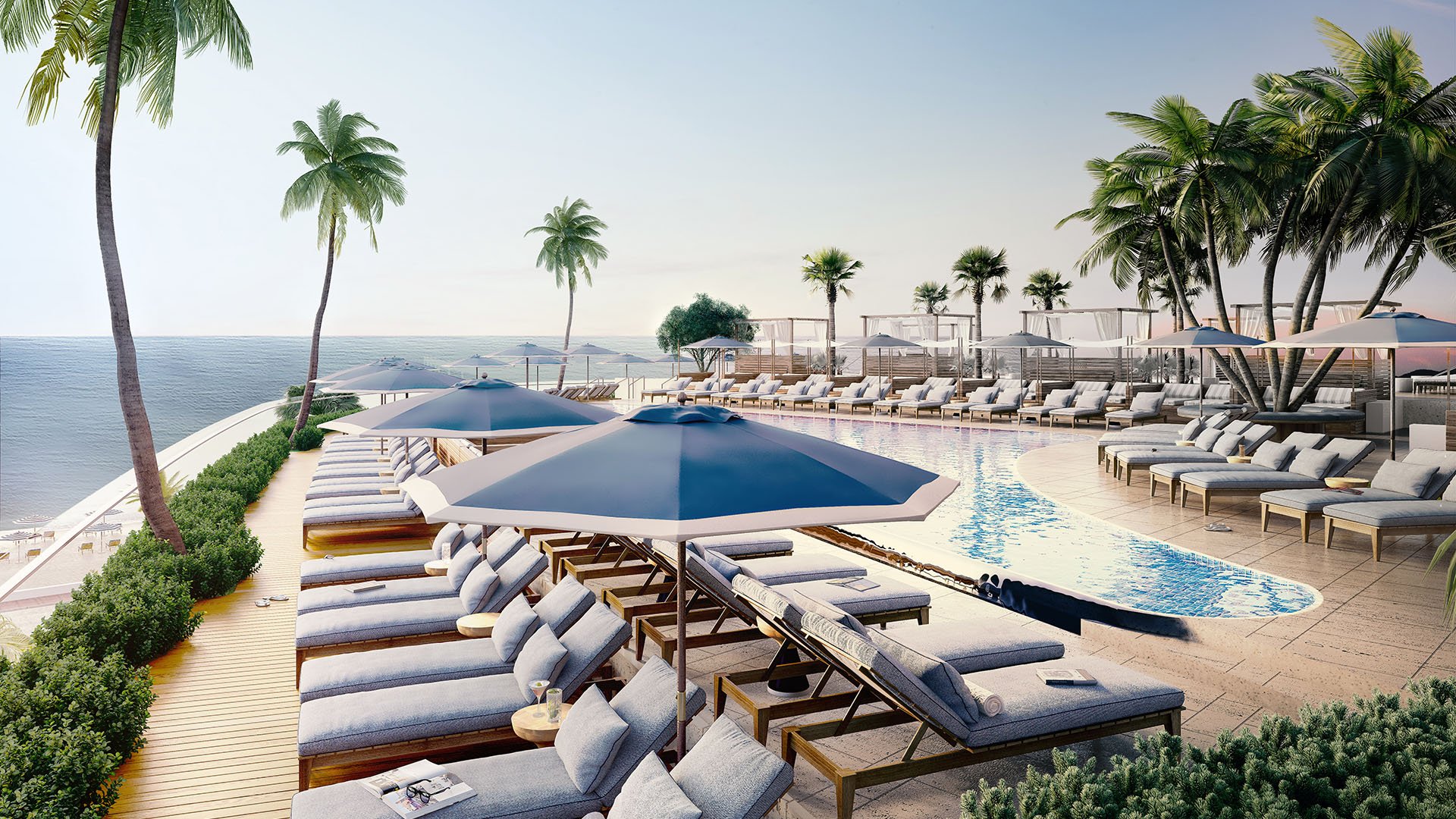 Oceanfront pool terrace with palm trees, umbrella-shaded loungers, and cabanas at Four Seasons Residences Fort Lauderdale in Fort Lauderdale, showcasing luxury and ultra luxury condos with resort-style leisure spaces.