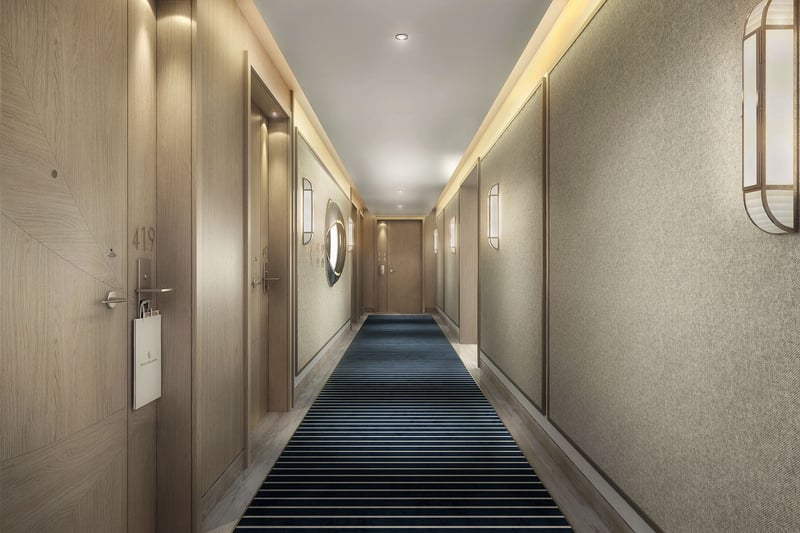 Private residence hallway with warm wood doors, textured walls, and striped carpet at Four Seasons Residences Fort Lauderdale in Fort Lauderdale, reflecting luxury and ultra luxury condos with tailored residential corridors.