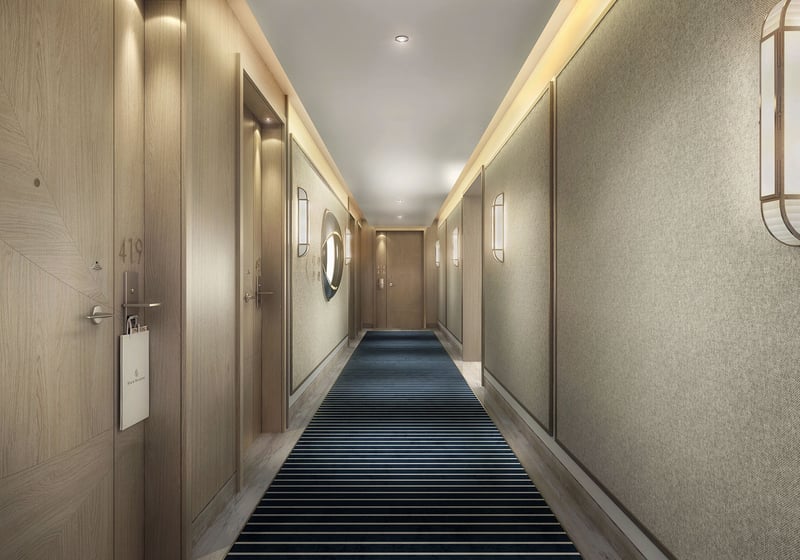 Private residence hallway with warm wood doors, textured walls, and striped carpet at Four Seasons Residences Fort Lauderdale in Fort Lauderdale, reflecting luxury and ultra luxury condos with tailored residential corridors.