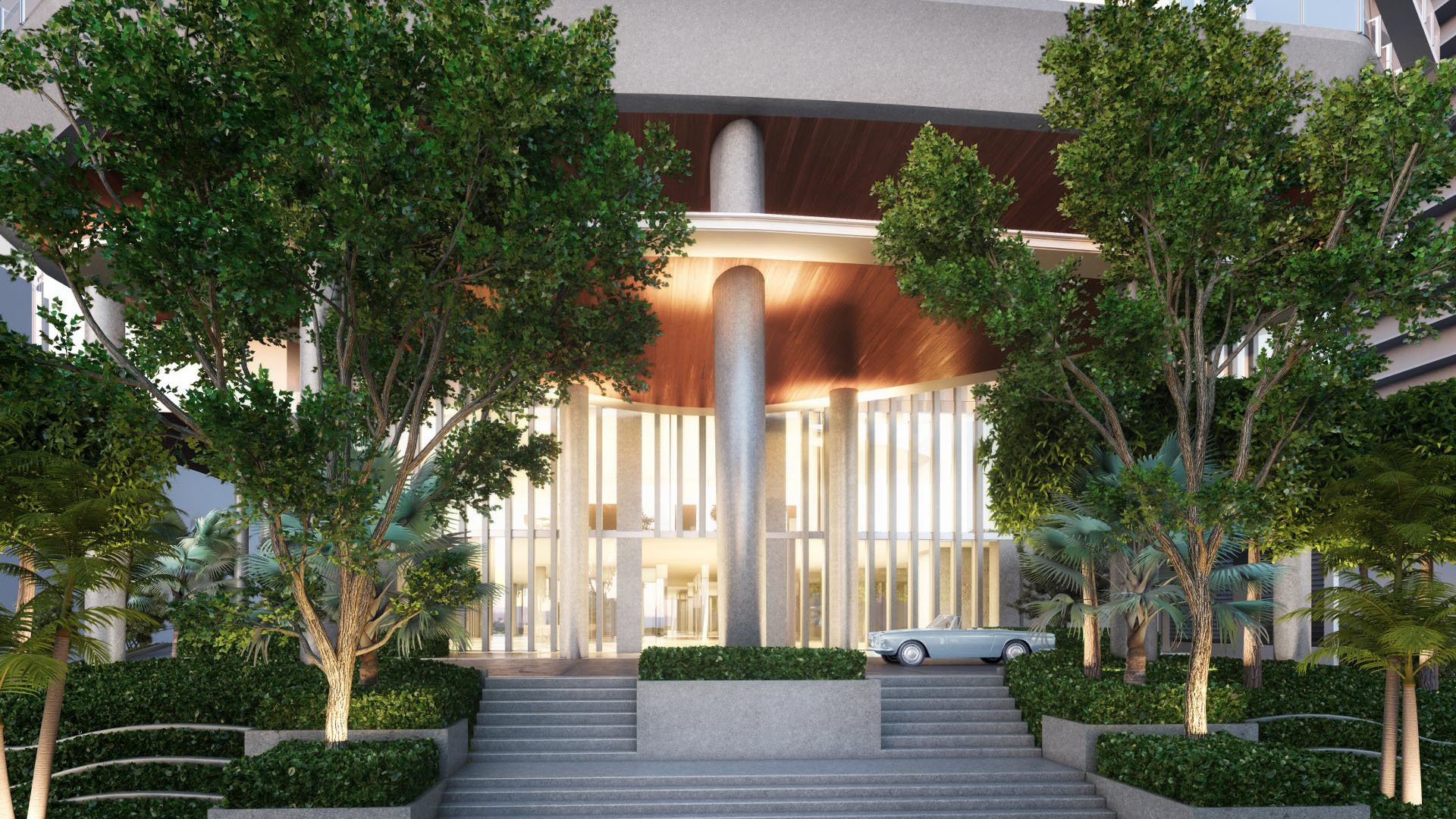 Tree-lined front entrance canopy with illuminated columns and lush landscaping at Four Seasons Residences Fort Lauderdale in Fort Lauderdale, introducing luxury and ultra luxury condos with a grand tropical arrival.