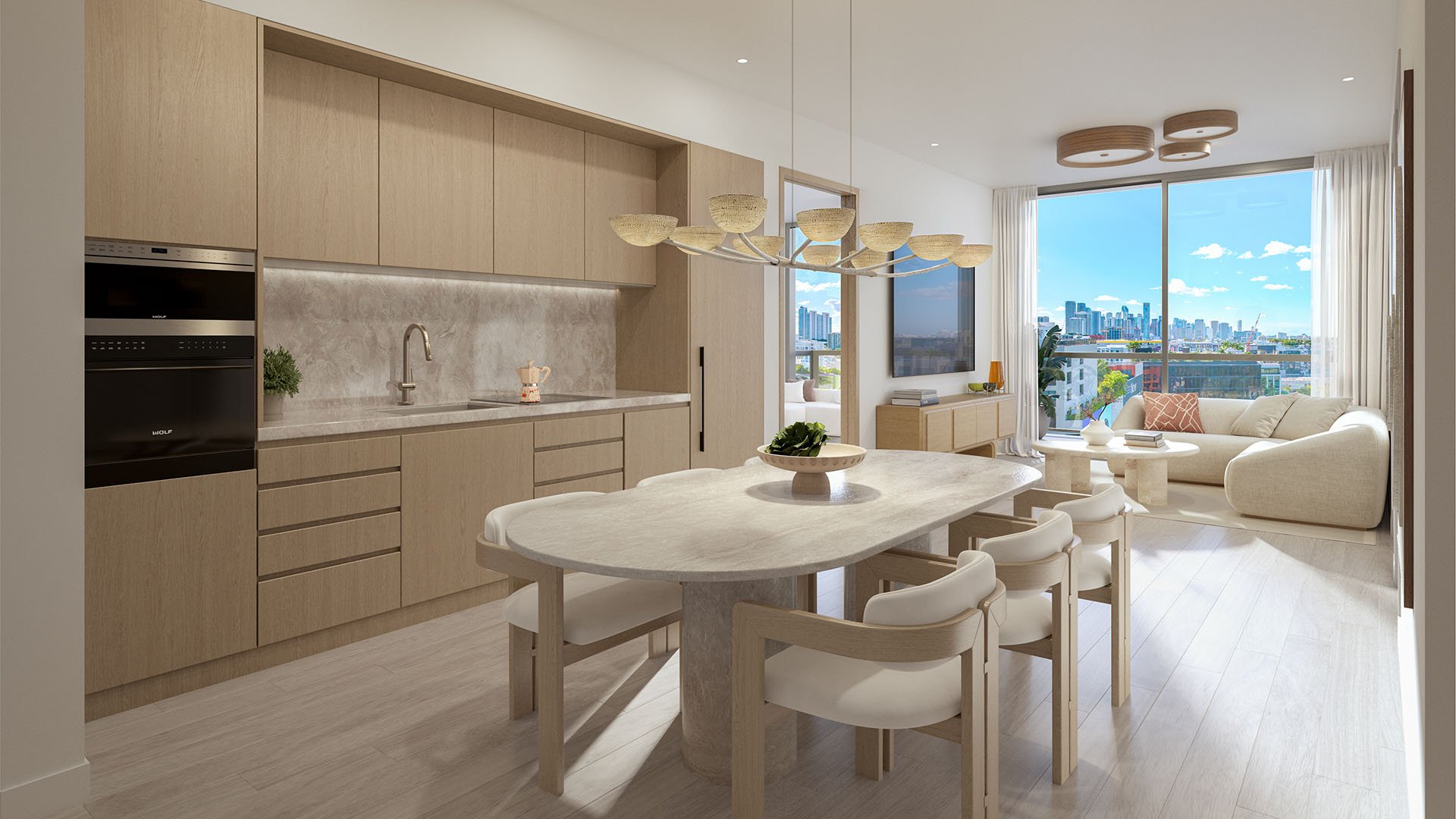 Chef kitchen and dining area at Frida Kahlo Residences in Wynwood, showcasing luxury and ultra luxury condos with light wood cabinetry, stone surfaces, and a bright skyline view through large windows.