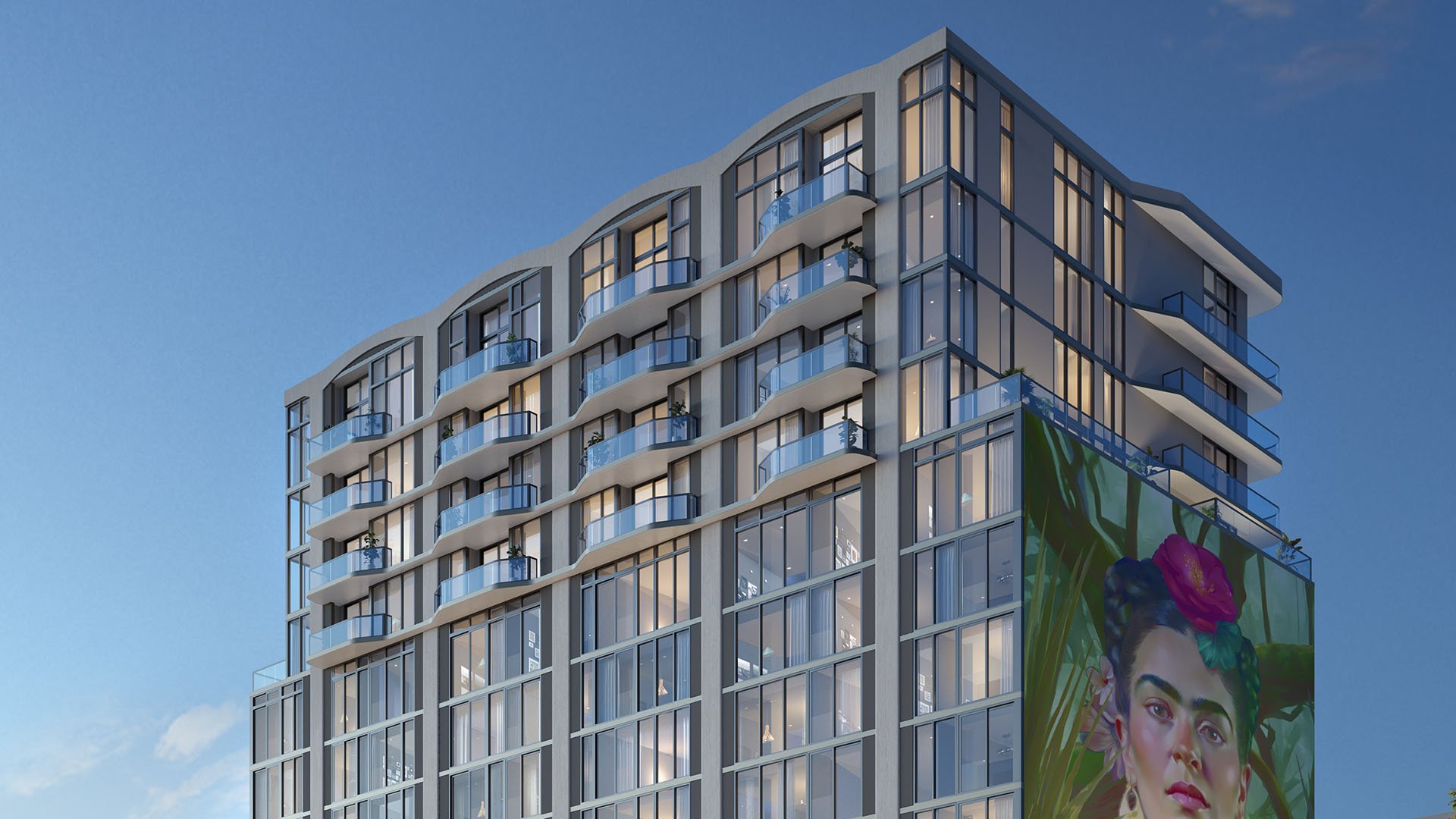 Curved condo exterior at Frida Kahlo Residences in Wynwood, highlighting luxury and ultra luxury condos with glass-railed balconies, expansive windows, and a large Frida Kahlo mural on the facade.