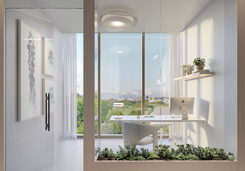 Glass-walled office at Frida Kahlo Residences in Wynwood, reflecting luxury and ultra luxury condos living with a minimalist desk, floor-to-ceiling windows, and a bright tree-lined view.