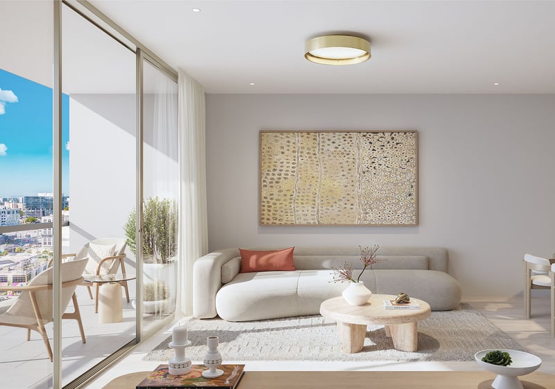 Sunlit living room at Frida Kahlo Residences in Wynwood, styled for luxury and ultra luxury condos with a soft neutral sofa, balcony lounge, large artwork, and open city views.