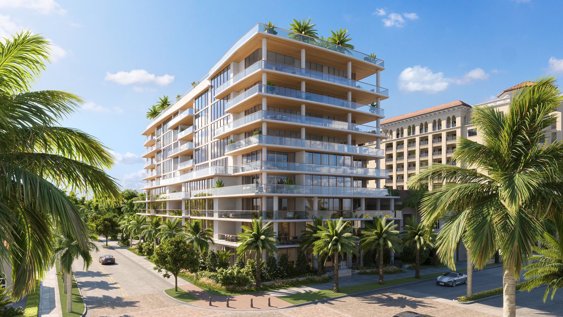 Aerial corner view of Glass House Boca Raton with glass balconies, rooftop terrace and palm-lined streets, representing luxury and ultra luxury preconstruction condos in Boca Raton, Florida.