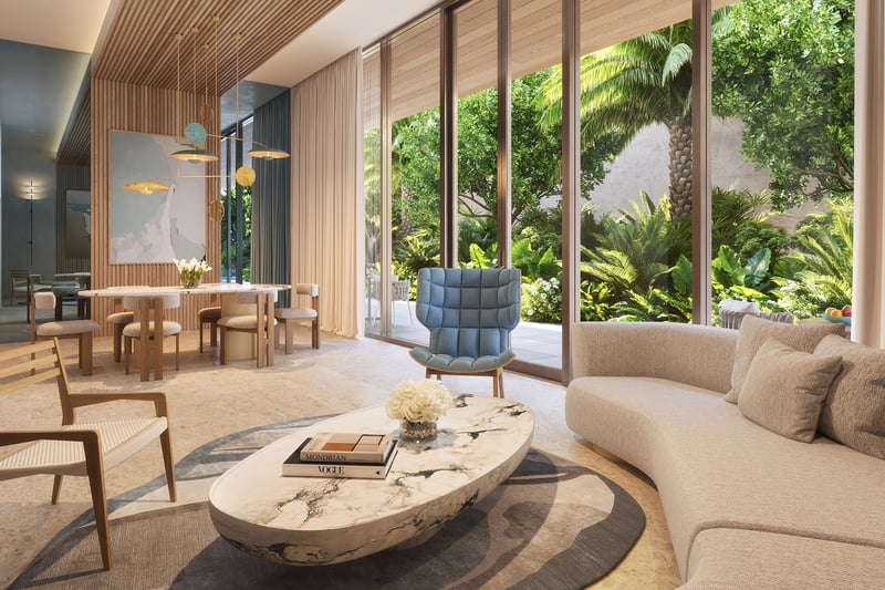 Glass House Boca Raton Palmetto Lounge social room with dining table and marble coffee table, floor-to-ceiling windows to tropical gardens, showcasing luxury and ultra luxury preconstruction condos amenities in Boca Raton, Florida.