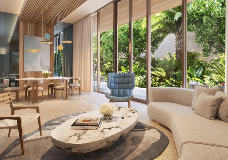 Glass House Boca Raton Palmetto Lounge social room with dining table and marble coffee table, floor-to-ceiling windows to tropical gardens, showcasing luxury and ultra luxury preconstruction condos amenities in Boca Raton, Florida.