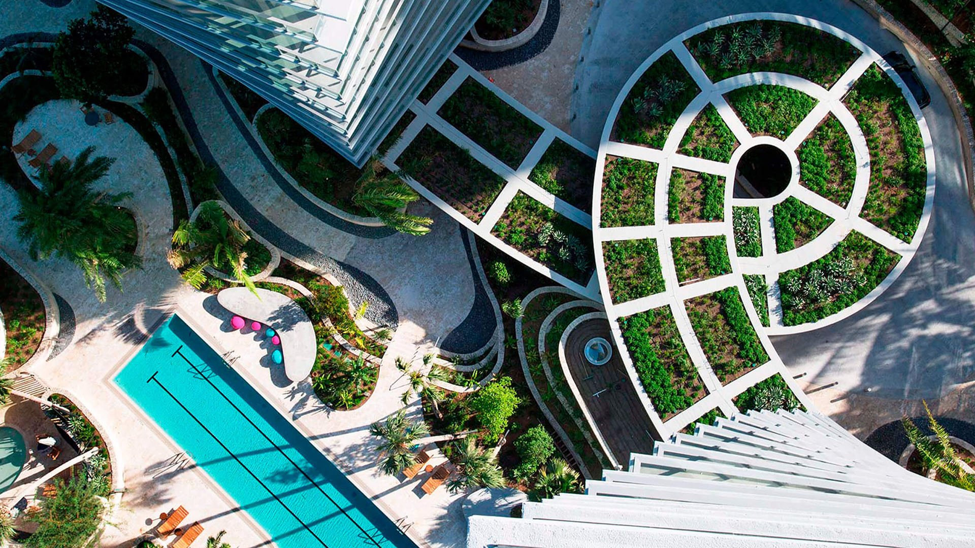 Grove at Grand Bay, Coconut Grove luxury and ultra luxury condos with an aerial view of the lap pool, curved pathways, and a circular garden set between the towers.