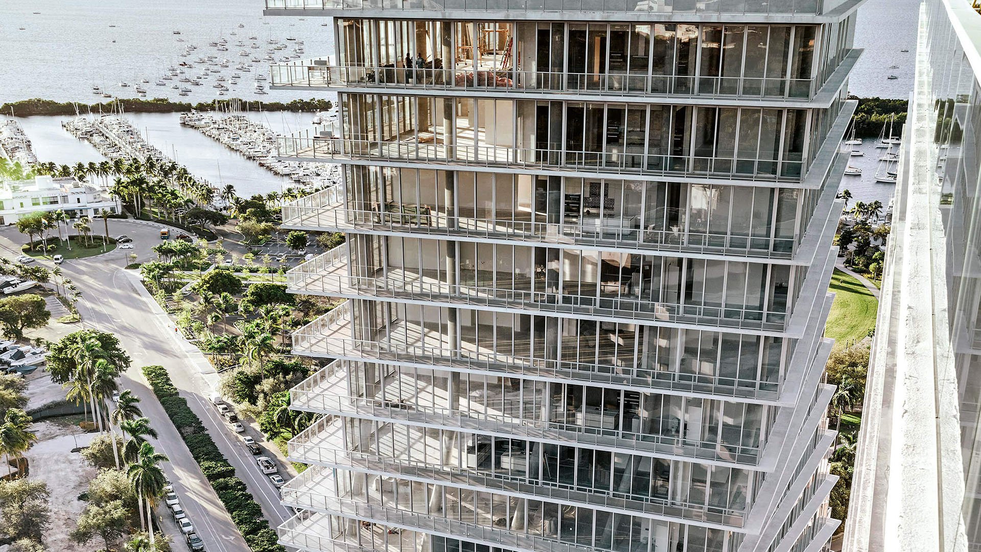 Grove at Grand Bay, Coconut Grove luxury and ultra luxury condos with a close aerial view of glass balconies and expansive corner terraces overlooking the marina and waterfront road.