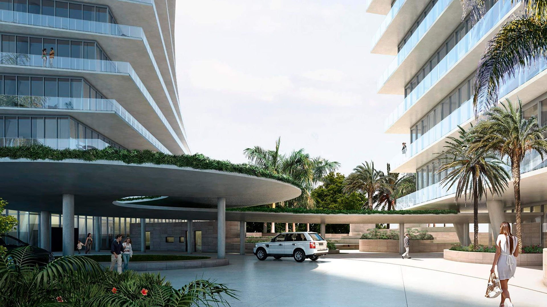 Grove at Grand Bay, Coconut Grove luxury and ultra luxury condos with a covered arrival court, round porte cochere, landscaped planters, and the towers rising on both sides.