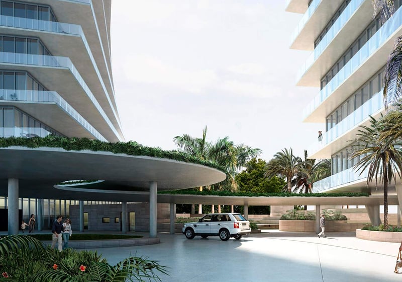 Grove at Grand Bay, Coconut Grove luxury and ultra luxury condos with a covered arrival court, round porte cochere, landscaped planters, and the towers rising on both sides.