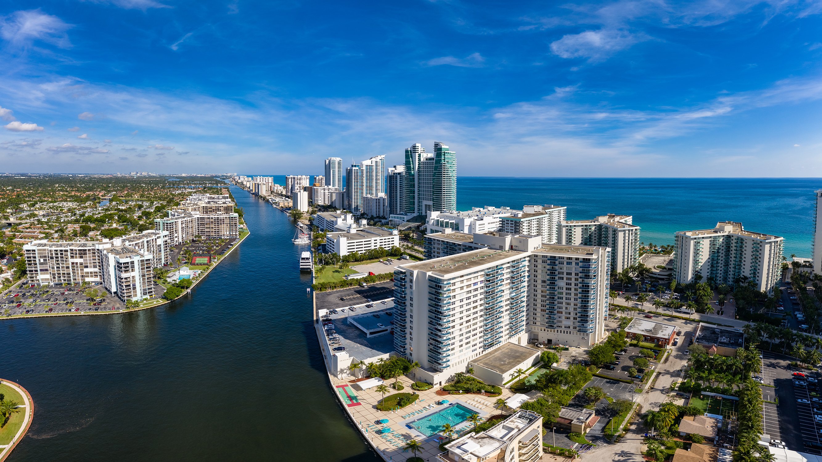 Hollywood, Florida coastal cityscape between Miami and Fort Lauderdale, beaches, canals and high‑rises; desirable zone for luxury and ultra luxury condos, with preconstruction and resale. Featuring urban, aerial, and view.