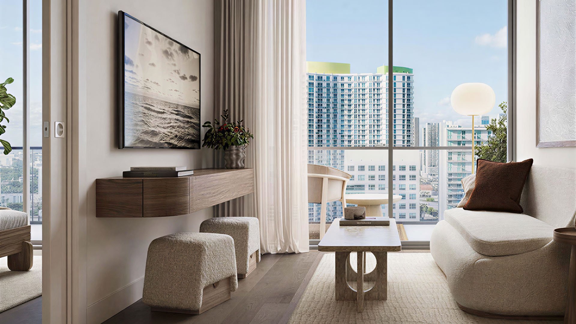 City-view sitting room at House of Wellness in Brickell preconstruction luxury and ultra luxury condos with a floating desk, lounge seating, and tall windows.
