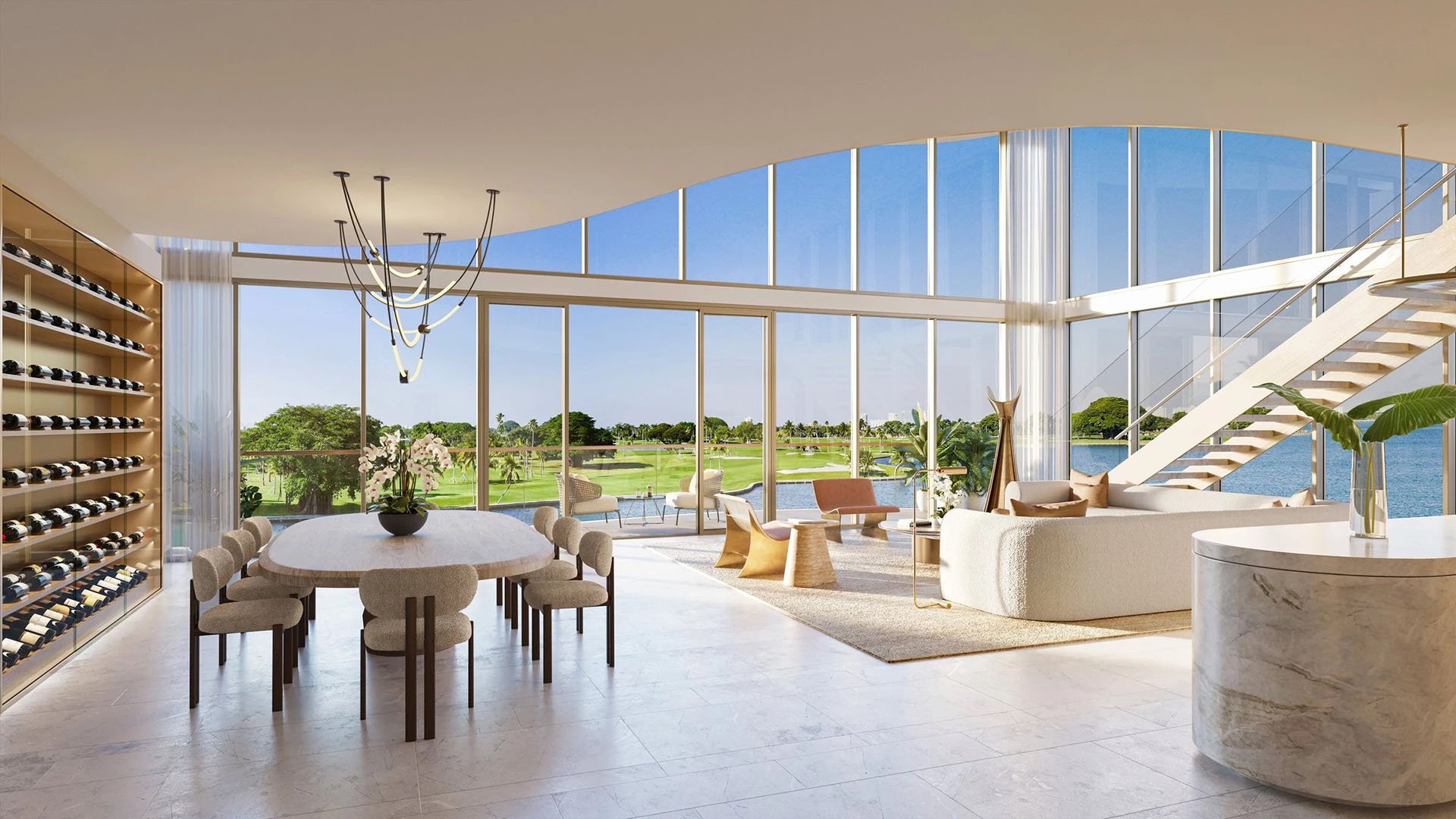 Indian Creek Residences and Yacht Club double-height living and dining room with wine wall, curved glass and floating staircase, golf course and water views in Bay Harbor Islands, Miami area, Florida, luxury and ultra luxury preconstruction condos.