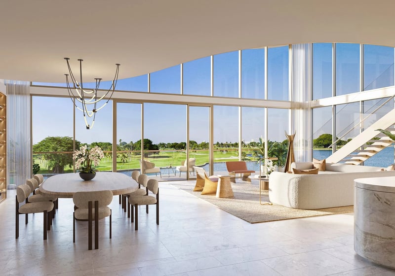 Indian Creek Residences and Yacht Club double-height living and dining room with wine wall, curved glass and floating staircase, golf course and water views in Bay Harbor Islands, Miami area, Florida, luxury and ultra luxury preconstruction condos.