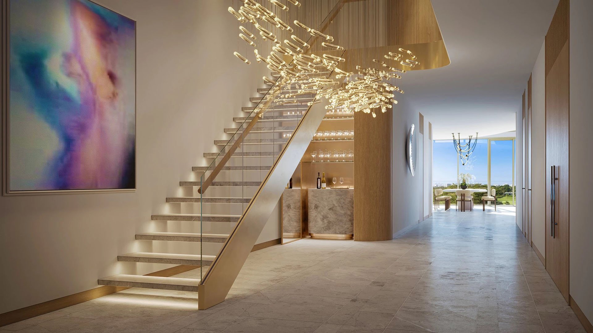 Indian Creek Residences and Yacht Club duplex entry foyer with floating staircase and sculptural chandelier, modern bar and gallery art, Bay Harbor Islands, Miami area, Florida, luxury and ultra luxury preconstruction condos interiors.