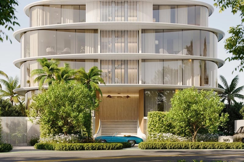 Indian Creek Residences and Yacht Club arrival entrance and porte cochere with lush landscaping and curved glass facade, Bay Harbor Islands, Miami area, Florida, luxury and ultra luxury preconstruction condos waterfront address.