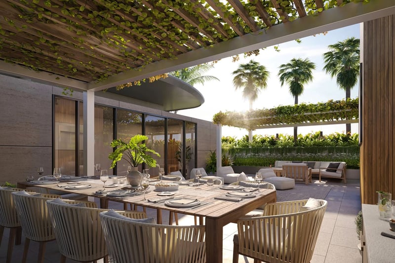 Indian Creek Residences and Yacht Club outdoor dining terrace under vine pergola with lounge seating and tropical landscaping, Bay Harbor Islands, Miami area, Florida, luxury and ultra luxury preconstruction condos amenities.