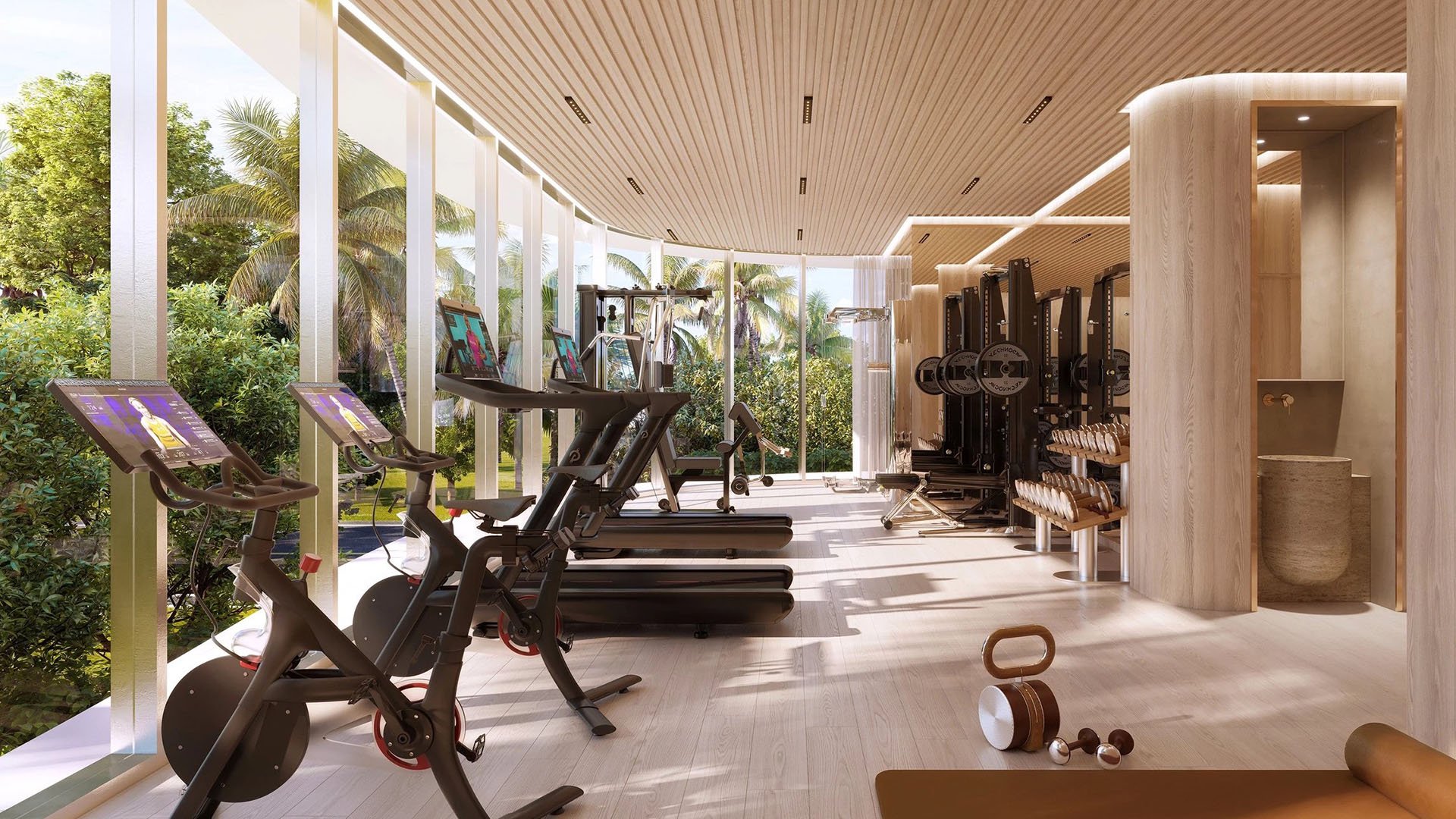 Indian Creek Residences and Yacht Club residents fitness center with treadmills, bikes and strength training equipment, floor-to-ceiling windows, Bay Harbor Islands, Miami area, Florida, luxury and ultra luxury preconstruction condos.