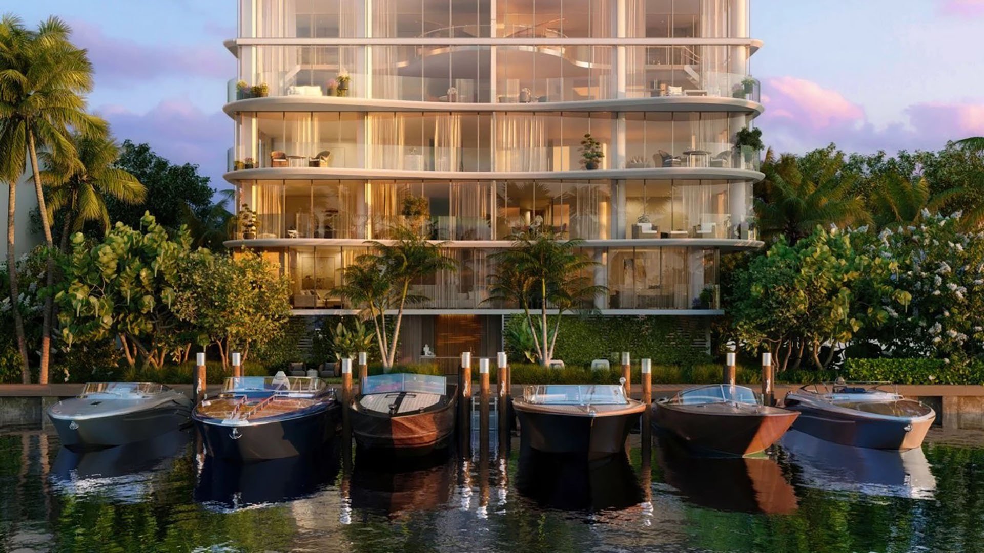 Indian Creek Residences and Yacht Club in Bay Harbor Islands, Miami, Florida modern glass waterfront condo building and yacht club marina with luxury boats, representing ultra luxury preconstruction condos with private dockage.